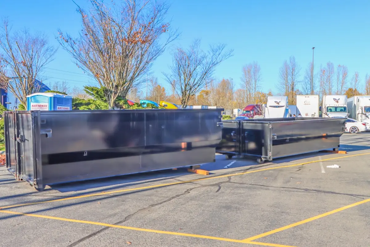 Professional dumpster rental service with roll-off container on residential driveway in Oakland Park